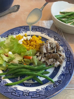 A picture of Chicken Shawarma w/ White Sauce and Fluffy Yellow Rice.