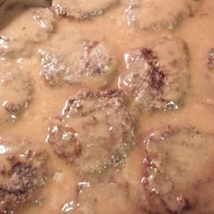 A picture of Hamburger Steak With Onions And Gravy.