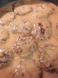 A picture of Hamburger Steak With Onions And Gravy.
