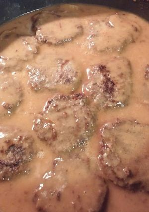 A picture of Hamburger Steak With Onions And Gravy.