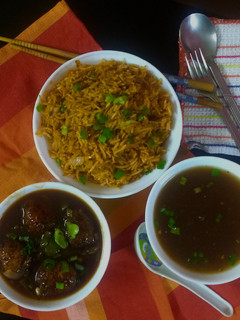 A picture of Chainese manchurian with soup and fried rice.