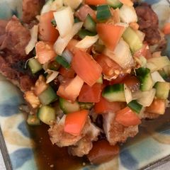 A picture of Fried chicken with summer vegetable sauce.