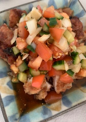A picture of Fried chicken with summer vegetable sauce.