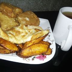 A picture of Plantain, bread in egg,egg with Tea.