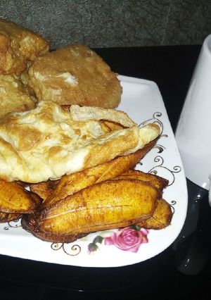 A picture of Plantain, bread in egg,egg with Tea.