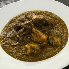 A picture of Chicken curry with greens.