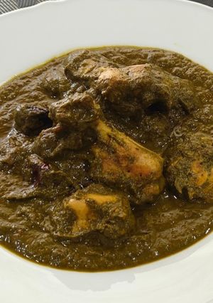 A picture of Chicken curry with greens.