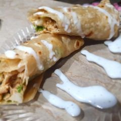 A picture of Paratha roll with mayo souce.