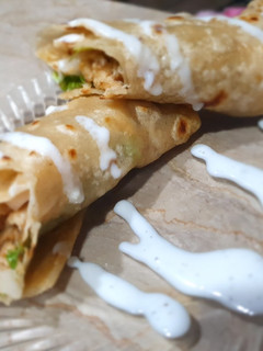 A picture of Paratha roll with mayo souce.