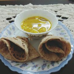 A picture of Arbi curry and Phulka.