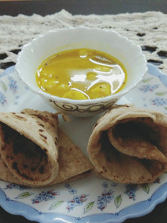 A picture of Arbi curry and Phulka.