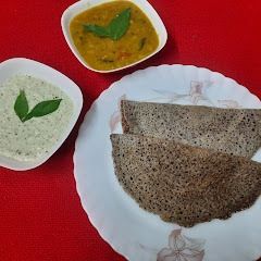 A picture of Ragi dosa with sambar and chutney.