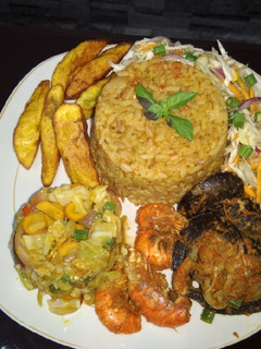 A picture of Jollof,fried plantain,fresh n fried veggie,pepered shrimp&snail.