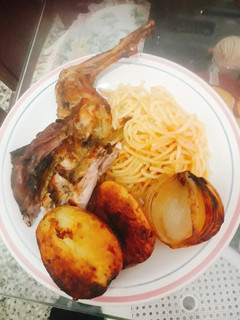Una foto de Conejo al horno con papas y acompañado con tallarines