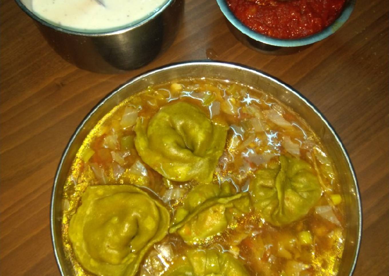 Spinach momos with gravy