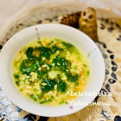A picture of Egg soup with spinach and wild garlic.