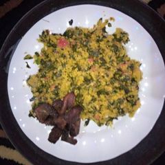 A picture of Couscous and moringa chicoins with fried meat.