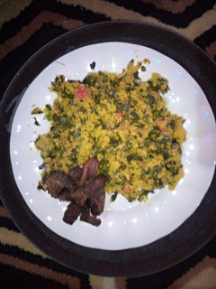 A picture of Couscous and moringa chicoins with fried meat.