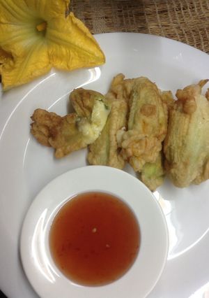A picture of Cheese stuffed pumpkin flowers with sweet chilli sauce.