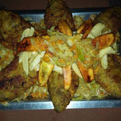 A picture of Fried fish with plantain and cabbage sauce.