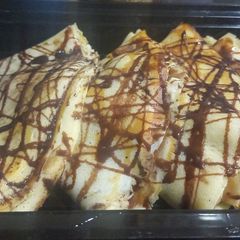 A picture of Banana crepe with chocolate syrup.