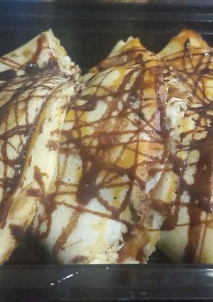 A picture of Banana crepe with chocolate syrup.