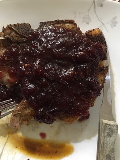 A picture of Pork with spicy orange cranberry sauce.