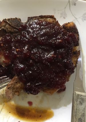 A picture of Pork with spicy orange cranberry sauce.