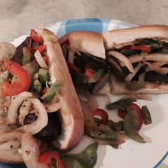A picture of Brauts With Peppers And Onions.