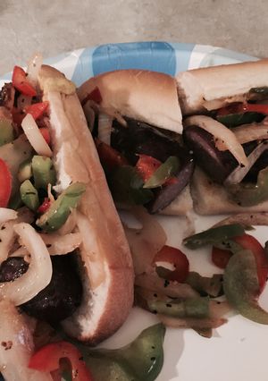 A picture of Brauts With Peppers And Onions.