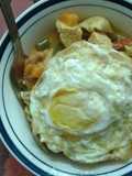 Tofu and mushroom soupy mixed pasta served with fried eggs.