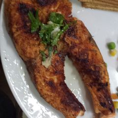 A picture of Grilled Salmon with parsley dressing.