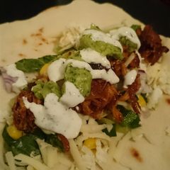 A picture of Pulled chicken with garlic sauce and avocado sauce.