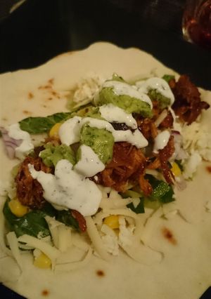 A picture of Pulled chicken with garlic sauce and avocado sauce.