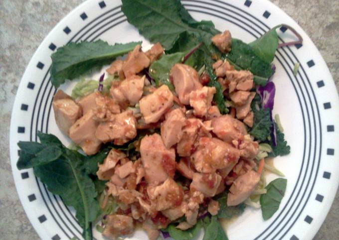 Roasted chicken in marinated sundried tomatoes atop kale salad