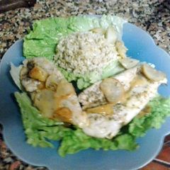 A picture of turkey breasts with pears and lime.