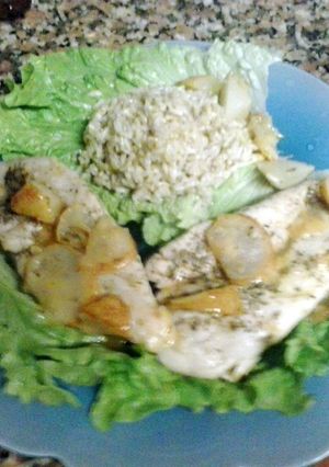 A picture of turkey breasts with pears and lime.