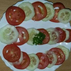 A picture of Tomato cucumber salad.