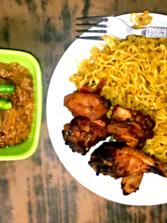 A picture of Smokey fried chicken with Peanut Chili sauce and Indo-mix Noodles.