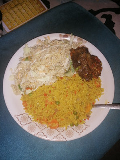A picture of Turmeric Jollof Rice with chicken wings.