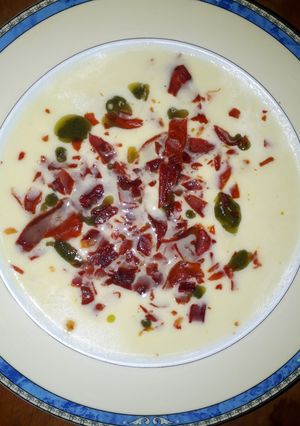 Una foto de Sopa de melón, con aceite de albahaca, y crujiente de jamón