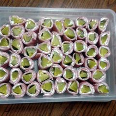 A picture of ham and pickle rolls.