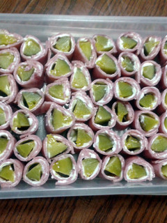 A picture of ham and pickle rolls.