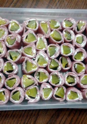 A picture of ham and pickle rolls.