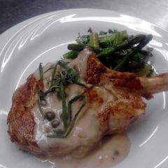 A picture of seared veal chop with creamy caper burr Blanc and wild rice pilaf.