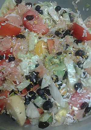 A picture of Fruit nuts and a vegetable salad.