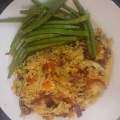 A picture of Nasi Goreng chicken with buttered beans.