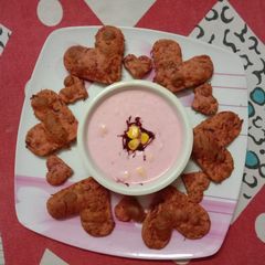 A picture of Beetroot Puri and beetroot raita witn sweet corn.