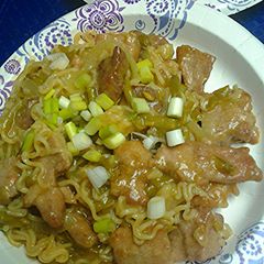 A picture of Ramen noodles pork and green bean stirfry.