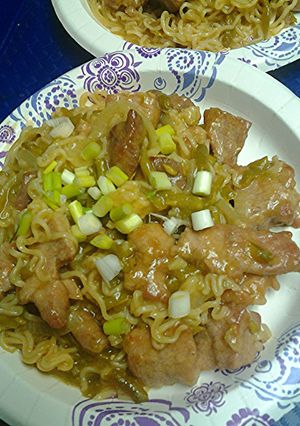 A picture of Ramen noodles pork and green bean stirfry.